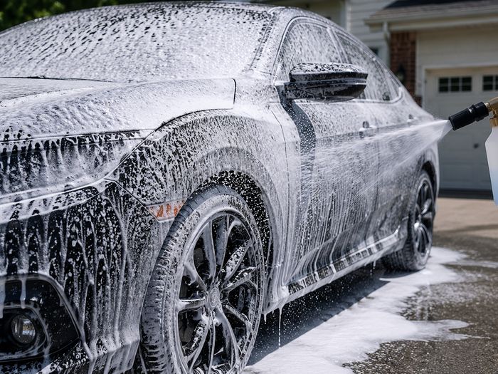 Thick foam pre-wash being applied to a car